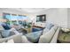Bright and airy living room featuring stylish furnishings, a large TV, and access to an outdoor balcony at 6 Academy S Way # 23A, St Petersburg, FL 33711