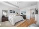 Spacious main bedroom with hardwood floors, tray ceiling, ceiling fan, and serene decor at 6 Academy S Way # 23A, St Petersburg, FL 33711