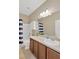 Well-lit bathroom featuring a shower-tub combo with striped curtain and ample vanity storage at 6116 Magnolia Park Blvd, Riverview, FL 33578