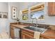 Kitchen sink features include wood countertops, stone backsplash, stainless steel sink and faucet, and bright lighting at 6330 Quail Ridge Dr, Tampa, FL 33625