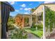 Outdoor seating area with decorative privacy screen and well-maintained landscaping at 646 16Th Ne Ave, St Petersburg, FL 33704