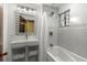 The bathroom includes white tile, modern vanity, bathtub, and shower at 646 16Th Ne Ave, St Petersburg, FL 33704