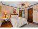 A charming bedroom features a ceiling fan, area rug, and a bed at 646 16Th Ne Ave, St Petersburg, FL 33704
