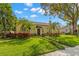 Charming yellow home with a spanish tile roof surrounded by mature trees and landscaping at 646 16Th Ne Ave, St Petersburg, FL 33704