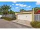 Charming garage with a light yellow finish and a white garage door, perfect for storing vehicles and equipment at 646 16Th Ne Ave, St Petersburg, FL 33704