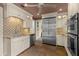 Bright kitchen with stainless steel appliances, custom cabinetry, granite countertops, and a stylish backsplash at 646 16Th Ne Ave, St Petersburg, FL 33704