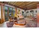 Charming living room featuring wood beam ceiling, beautiful rug, and lots of natural light from large windows at 646 16Th Ne Ave, St Petersburg, FL 33704