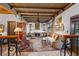 Elegant living room featuring beamed ceilings, a fireplace, and classic furnishings at 646 16Th Ne Ave, St Petersburg, FL 33704