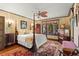Elegant main bedroom with a four-poster bed, decorative ceiling fan, and custom window treatments, creating a luxurious retreat at 646 16Th Ne Ave, St Petersburg, FL 33704