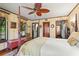 Luxurious main bedroom featuring a four-poster bed, decorative ceiling fan, and access to a stylish ensuite bathroom at 646 16Th Ne Ave, St Petersburg, FL 33704