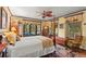 Charming main bedroom featuring a four-poster bed, decorative ceiling fan, and large windows with elegant curtains at 646 16Th Ne Ave, St Petersburg, FL 33704