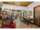 Elegant office featuring dark wood desk, seating, and an open view into formal dining area at 646 16Th Ne Ave, St Petersburg, FL 33704