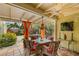 Covered patio features comfortable seating, ceiling fan, and bright curtains with lush landscaping at 646 16Th Ne Ave, St Petersburg, FL 33704