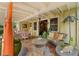 Charming covered patio featuring comfortable seating, ceiling fans, and elegant decor perfect for outdoor living and entertaining at 646 16Th Ne Ave, St Petersburg, FL 33704
