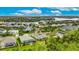 Stunning aerial view of a coastal home featuring a screened pool and lush landscaping in a waterfront community at 706 Manns Harbor Dr, Apollo Beach, FL 33572
