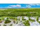 A beautiful home with a screened-in pool in a lush, green neighborhood, located near a pond at 706 Manns Harbor Dr, Apollo Beach, FL 33572