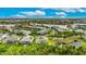Aerial view of a gated community with lake access, lush vegetation, and beautifully landscaped properties at 706 Manns Harbor Dr, Apollo Beach, FL 33572