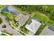 A bird's eye view shows a home with a screened in pool, located near a pond and green vegetation at 706 Manns Harbor Dr, Apollo Beach, FL 33572