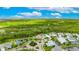 Expansive aerial view showcasing the home's location amidst lush greenery and serene ponds in a beautiful community at 706 Manns Harbor Dr, Apollo Beach, FL 33572