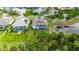 Aerial shot showcasing a home with a screened pool area, complemented by mature trees and landscaping at 706 Manns Harbor Dr, Apollo Beach, FL 33572