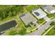 Aerial view of a house that has a screened-in pool, and is next to a scenic pond at 706 Manns Harbor Dr, Apollo Beach, FL 33572