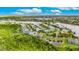 Aerial of lakefront property in a beautiful, gated community with mature landscaping at 706 Manns Harbor Dr, Apollo Beach, FL 33572