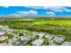 Aerial view of a beautiful home with a screened-in pool, located next to a peaceful pond at 706 Manns Harbor Dr, Apollo Beach, FL 33572
