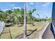 Professionally landscaped backyard with Zoysia grass and a white picket fence at 706 Manns Harbor Dr, Apollo Beach, FL 33572