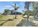 Beautifully landscaped backyard with large grassy area and mature trees at 706 Manns Harbor Dr, Apollo Beach, FL 33572