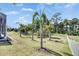 Well-manicured lawn with palm trees and white picket fence at 706 Manns Harbor Dr, Apollo Beach, FL 33572