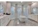 A stunning bathroom featuring dual sinks, a soaking tub, and dual glass showers at 706 Manns Harbor Dr, Apollo Beach, FL 33572
