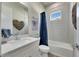 Modern bathroom featuring white countertops, patterned tile, and a bathtub with a shower at 706 Manns Harbor Dr, Apollo Beach, FL 33572