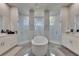 Luxurious bathroom boasts a freestanding tub, dual vanities, and separate glass shower enclosures at 706 Manns Harbor Dr, Apollo Beach, FL 33572