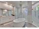 This gorgeous bathroom features a soaking tub, dual vanities, and walk-in glass showers at 706 Manns Harbor Dr, Apollo Beach, FL 33572