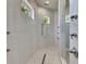 Modern walk-in shower with sleek fixtures, rain shower head, and tiled walls at 706 Manns Harbor Dr, Apollo Beach, FL 33572