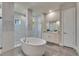 Elegant bathroom with freestanding tub, glass shower, and stylish vanity offers a spa-like experience at 706 Manns Harbor Dr, Apollo Beach, FL 33572