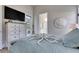 Bright bedroom with pool view, wall-mounted TV, and coastal-themed decor at 706 Manns Harbor Dr, Apollo Beach, FL 33572