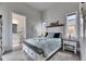 Bright bedroom features a coastal theme, en suite bathroom, and light blue bedding at 706 Manns Harbor Dr, Apollo Beach, FL 33572