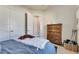 Cozy bedroom with a wood dresser, plush blanket, and nautical decor at 706 Manns Harbor Dr, Apollo Beach, FL 33572