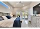 Comfortable bedroom with a view of the pool through sliding doors, featuring neutral tones and a cozy rug at 706 Manns Harbor Dr, Apollo Beach, FL 33572
