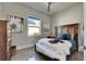 Cozy bedroom with a ceiling fan, beach-themed artwork, and a faux fur throw at 706 Manns Harbor Dr, Apollo Beach, FL 33572