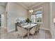 Bright dining room with large window, modern chandelier and neutral tones for elegant dining at 706 Manns Harbor Dr, Apollo Beach, FL 33572