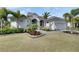 Attractive home exterior with a well-manicured lawn, lush landscaping, and elegant architectural details at 706 Manns Harbor Dr, Apollo Beach, FL 33572