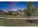 Beautiful home exterior with manicured lawn, lush landscaping, and elegant entryway under a twilight sky at 706 Manns Harbor Dr, Apollo Beach, FL 33572