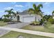 Beautiful home exterior with manicured lawn, lush landscaping, and a well-maintained driveway at 706 Manns Harbor Dr, Apollo Beach, FL 33572