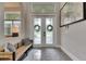 Inviting foyer featuring elegant double doors with decorative glass panels and a comfortable bench at 706 Manns Harbor Dr, Apollo Beach, FL 33572