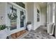 Charming front porch featuring double doors with wreath accents and a decorative welcome mat at 706 Manns Harbor Dr, Apollo Beach, FL 33572