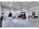 Spacious two car garage with tall ceilings and a golf cart parked inside at 706 Manns Harbor Dr, Apollo Beach, FL 33572