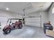 Bright and spacious two car garage with speckled epoxy flooring and a golf cart parked inside at 706 Manns Harbor Dr, Apollo Beach, FL 33572