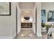 Elegant hallway featuring tiled floors, decorative wall art, and an inviting view of the home's interior at 706 Manns Harbor Dr, Apollo Beach, FL 33572